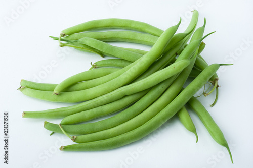 Freshly cut green beans photographed on white background