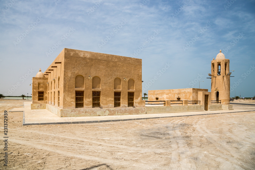 Historical old Mosque with a Minaret in Al Thakhira, Qatar, built from coral rock and limestone and cemented with a mud mortar.