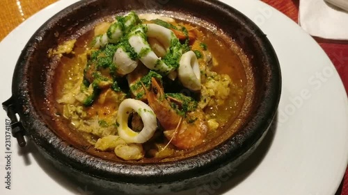 Tagine with seafood in a pottery, a traditional dish of Morocco photo