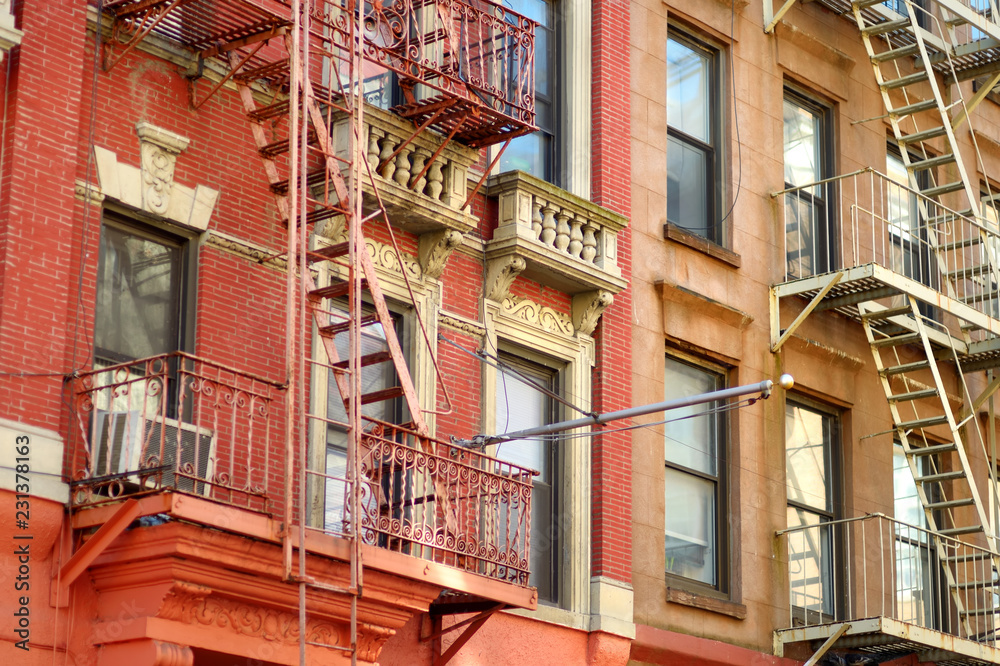 Close-up view of New York City apartment buildings with emergency stairs in Little Italy neighborhood of Manhattan NYC