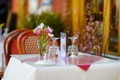 Small table set for dinner in outdoor cafe in Little Italy neighborhood in downtown Manhattan, New York City