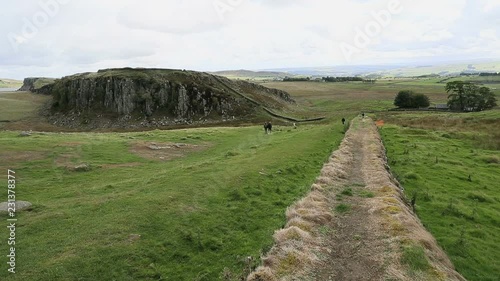 Hadrians Wall England Scotland border historic ruins. Hadrian's Wall was a defensive fortification in the Roman province of Britannia built in AD122. One of Britain's major ancient tourist attractions photo