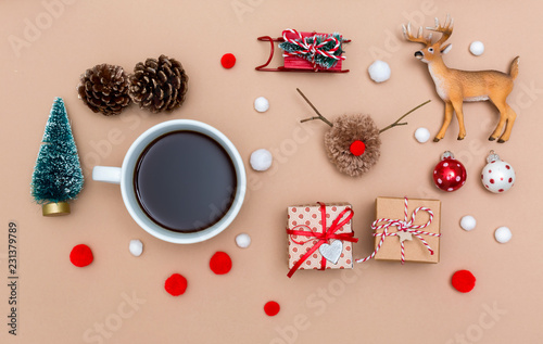 Christmas ornaments with coffee cup on a light brown paper background