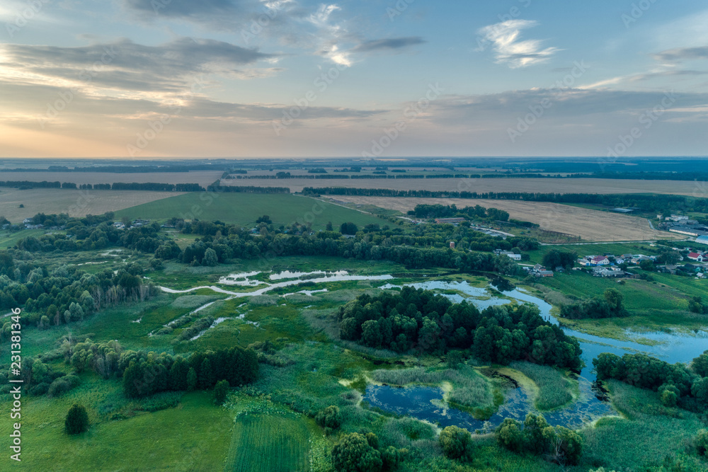 Fototapeta premium Russia, a typical rural settlement. Evening shot from the air