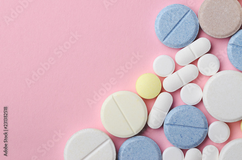 multi-colored tablets of different shapes with frame edge on pink background