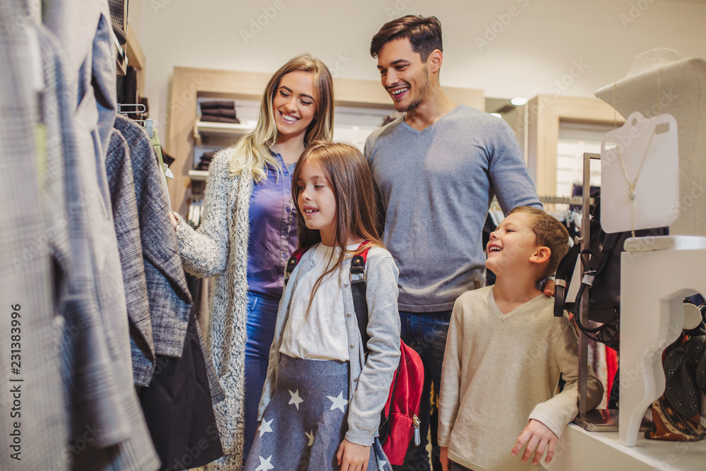 Fototapeta premium Family shopping for clothes and looking happy