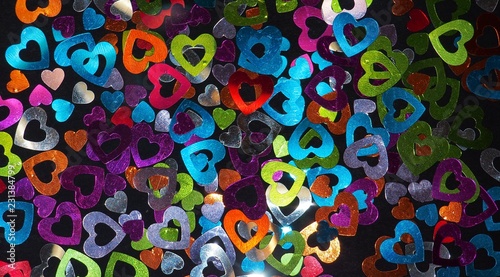 Colorful shiny hearts on a black background.