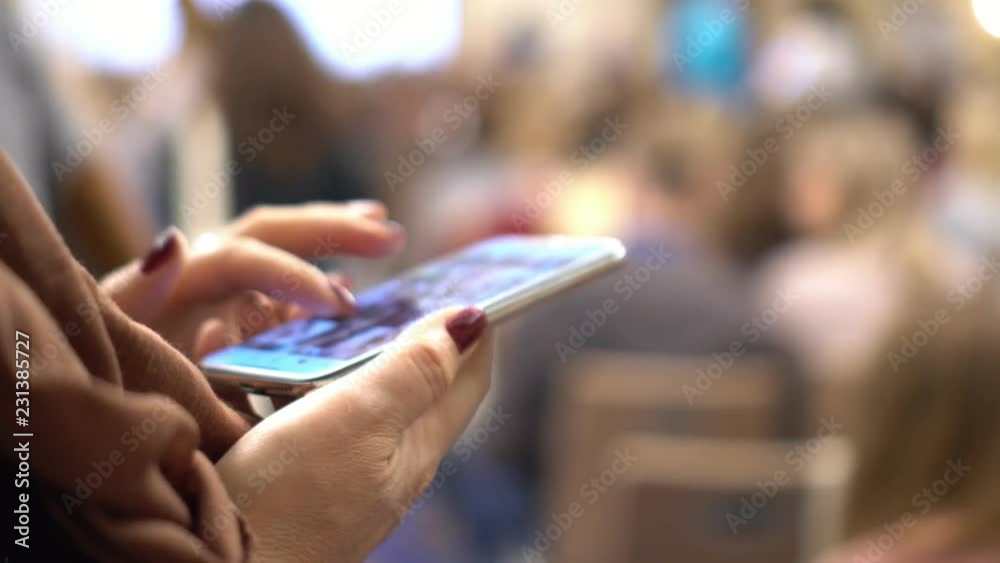 Conference. It is a lot of people. The woman works on the smartphone. Hands close up. Conference. It is a lot of people. The woman works on the smartphone. Hands close up.