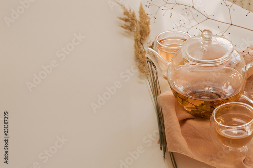 linden herbal tea in glass cups and teapot photo