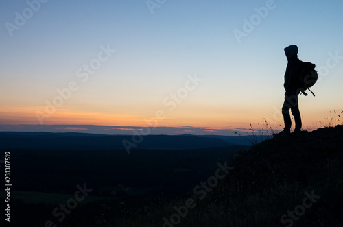 Man meets sunset on the top of the mountain.