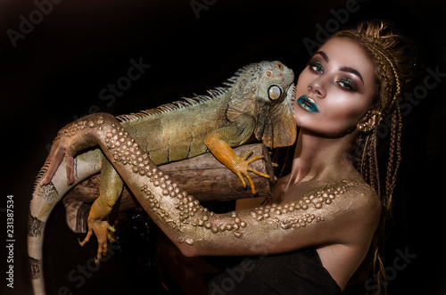beautiful halloween girl and green iguana
