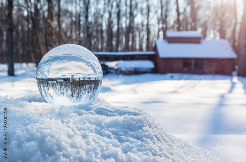 Crstal ball showing a Sugar shack and old barn in a boreal forest Quebec, Canada. photo