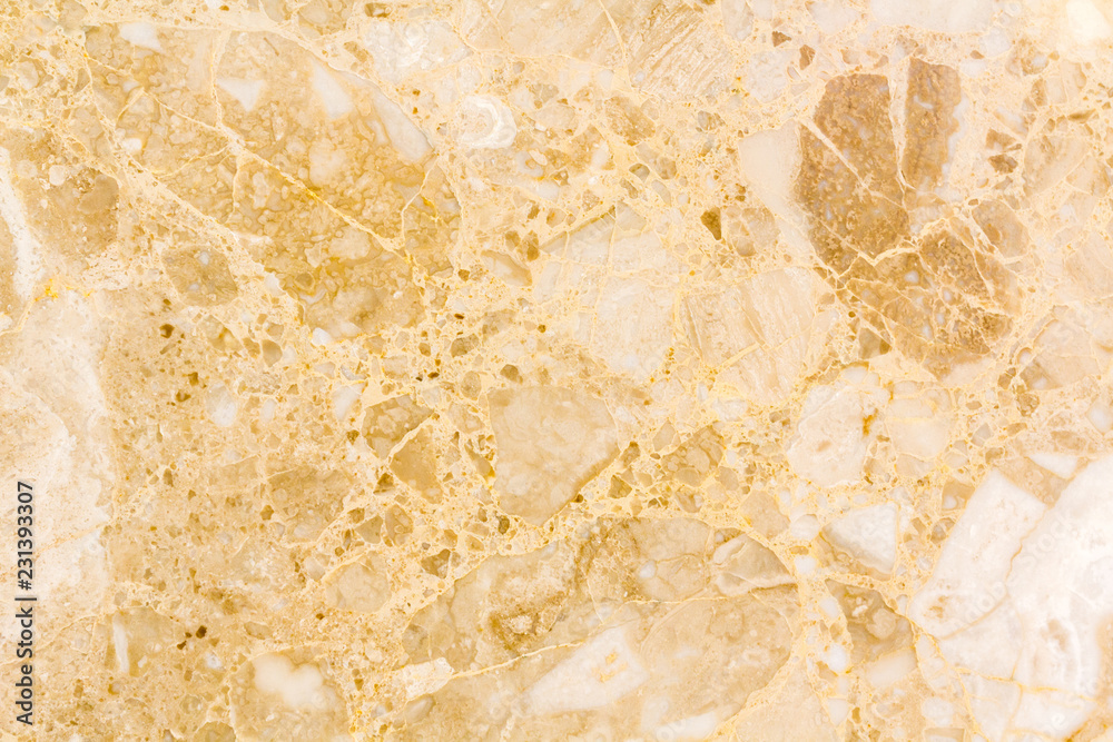Light marble texture background. Natural marble stone texture in warm colors. Background with small waves and a round pattern. Orange, gold, yellow and beige shades.