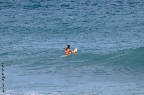 young female waiting for a wave to surf