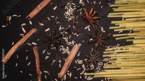 Fototapeta Naklejka Na Ścianę i Meble -  fettuccine pasta stick and the spices; cinnamon stick, star anise, cloves , cumin. food and culinary background