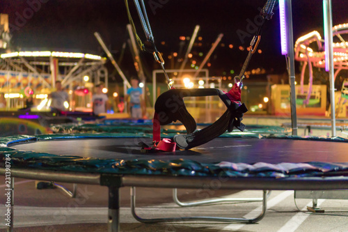 Canvas Print Bungee trampoline in amusement park at night.