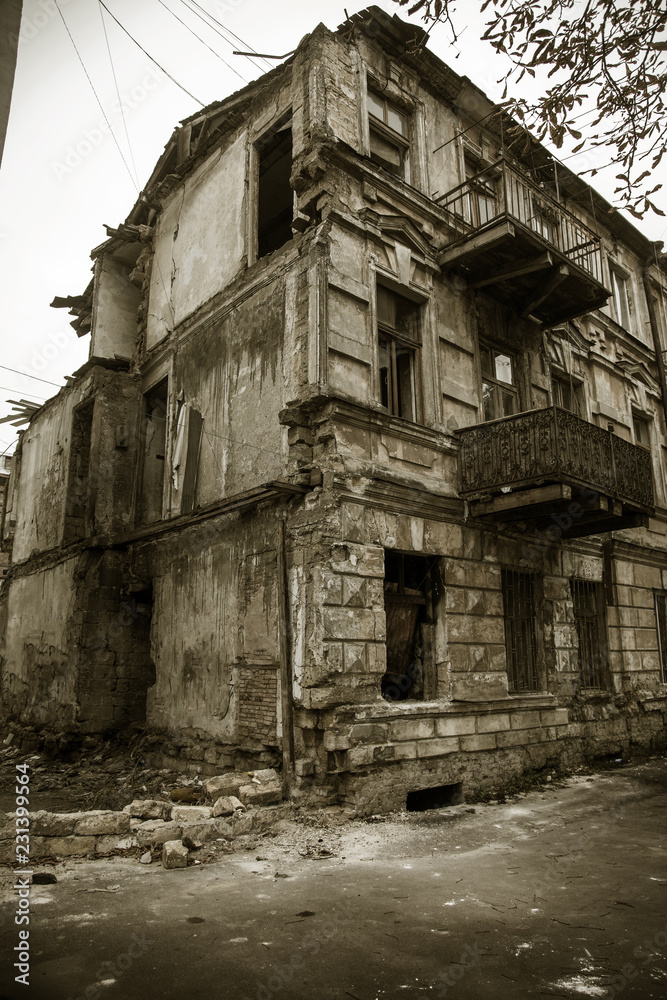 Ruins of an old abandoned city. Ruined house in which poor people live. Odessa, the ruins of a historic residential building. The ruins of an old earthquake-hit house. Lost city.