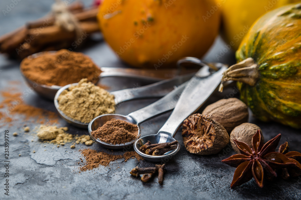 Pumpkin pie spices in measuring cups, rustic background Pumpkin pie spices in measuring cups, rustic background
