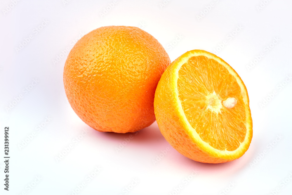 Fresh ripe oranges on light background. Whole and half of orange fruit. Healthy eating concept. Fresh ripe oranges on light background. Whole and half of orange fruit. Healthy eating concept.