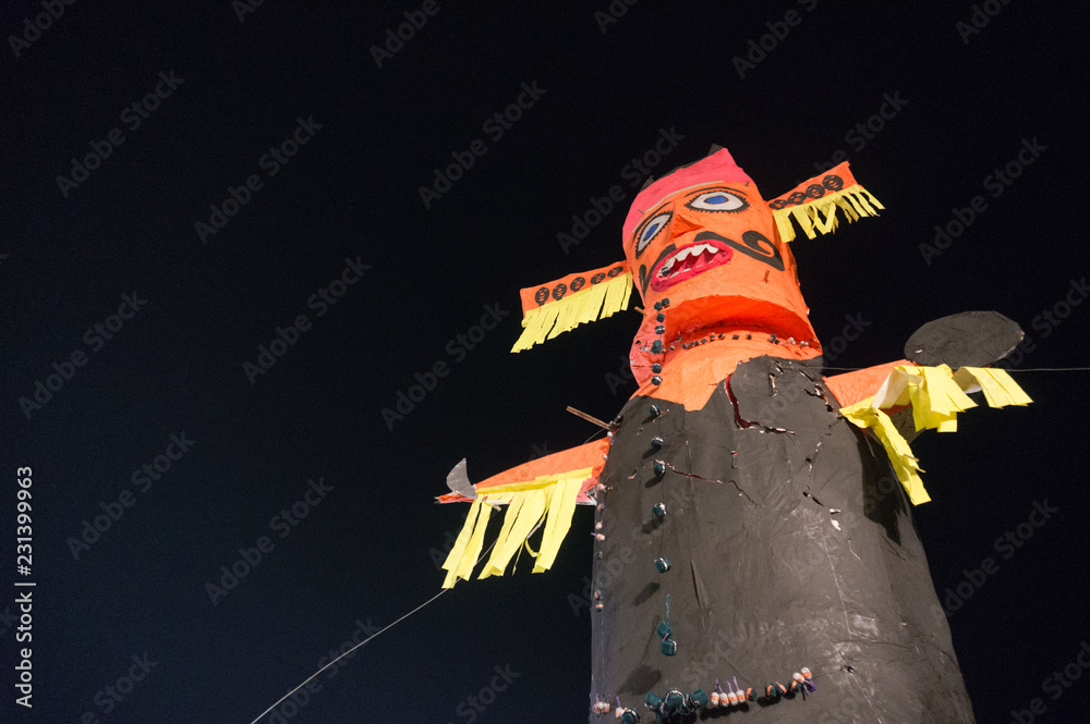 Ravan Ravana demon king evil standing against black night on hindu festival  of dussera. Shot upwards showing the ten heads, caricature face. This is  the central element of the festival's celebration Stock
