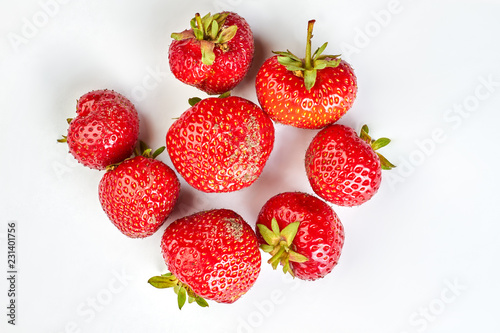 Fototapeta Naklejka Na Ścianę i Meble -  Heap of fresh strawberries on light background. Freshly picked garden strawberries. Nutritious summer berry.