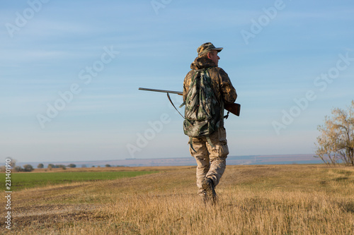 Hunter with a german drathaar and spaniel, pigeon hunting with dogs in reflective vests	