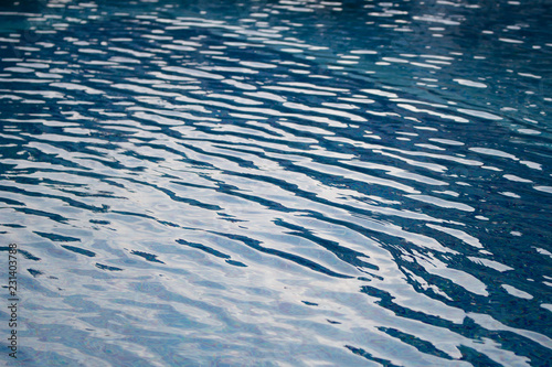 Waves on blue water surface in swimming pool