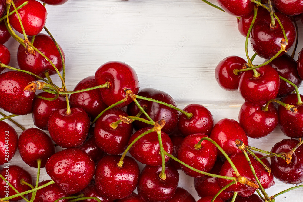 Close up ripe sweet cherries and copy space. Delicious summer berries and text space. Tasty seasonal fruit. Close up ripe sweet cherries and copy space. Delicious summer berries and text space. Tasty seasonal fruit.