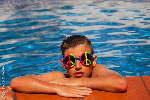Boy enjoying summer time in swimming pool