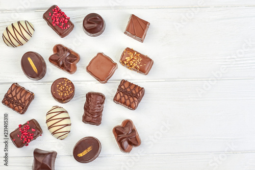 Assortment of chocolate candies and copy space. Variety of chocolate sweets on white background and text space.