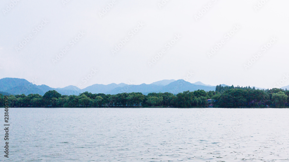 View of West Lake, with islands and hills in the distance, in Hangzhou, China View of West Lake, with islands and hills in the distance, in Hangzhou, China