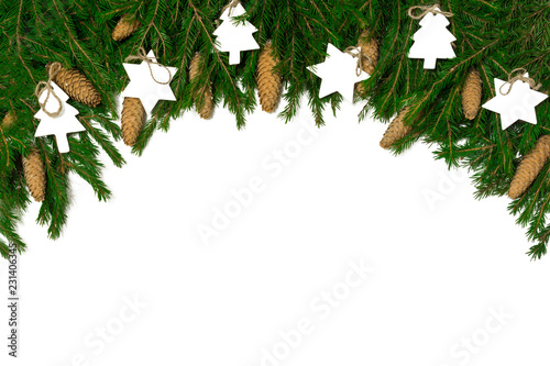Wide arch shaped Christmas border isolated on white, composed of fresh fir branches, cones and wood decorations
