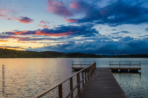 Wooden pier. Clouds over th...