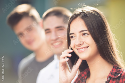 Portrait of beautiful teenage girl talking on the phone