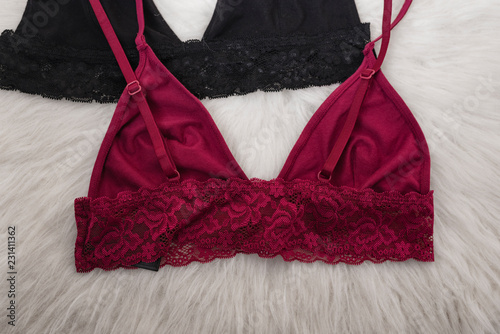 Burgundy and black bra on a wooden background. Fashion concept