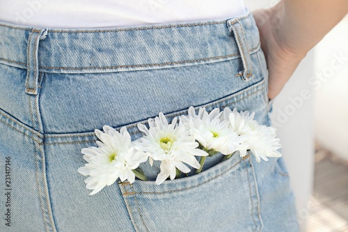 Woman with white flowers in back pocket photo