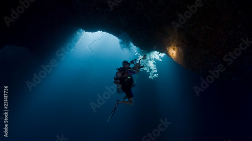 Scuba divers inside underwater cavern
