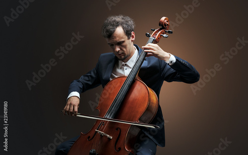 Lonely cellist composing on cello with nothing around 