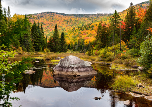 Fall colors of Lac Legault with Mont Kaaikop in the background, in cottage country in the Laurentians, Quebec, Canada.