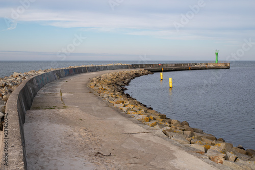 Entrance to a small fishing port by the sea. Coast in central europe.