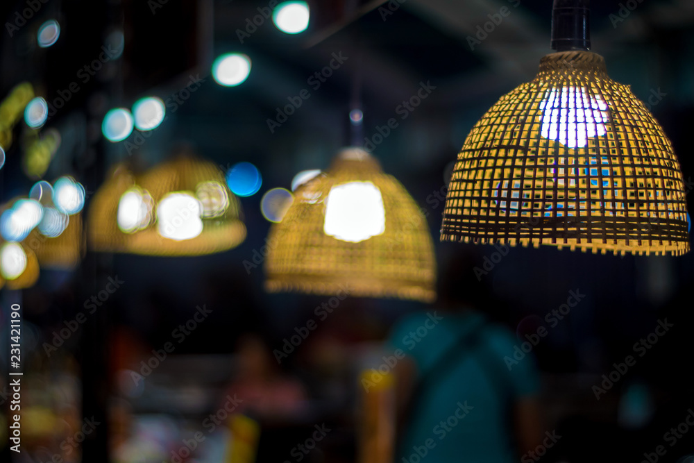 Fototapeta premium Lighting from light bulb in the bamboo weave hanging lamp