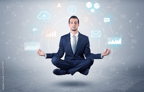 Elegant calm businessman levitates in yoga position with data circulation concept 