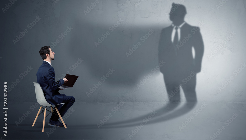 Humble businessman staying and offering stuffs to a huge angry bull shadow
Humble businessman staying and offering stuffs to a huge angry bull shadow