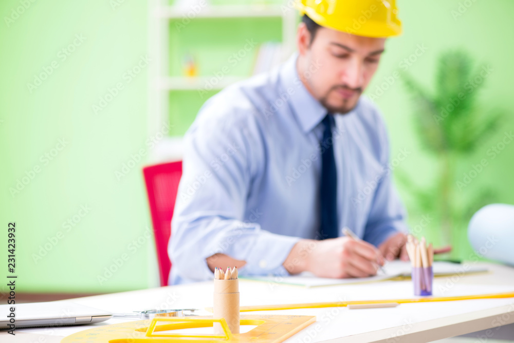 Young male architect working at the project Young male architect working at the project