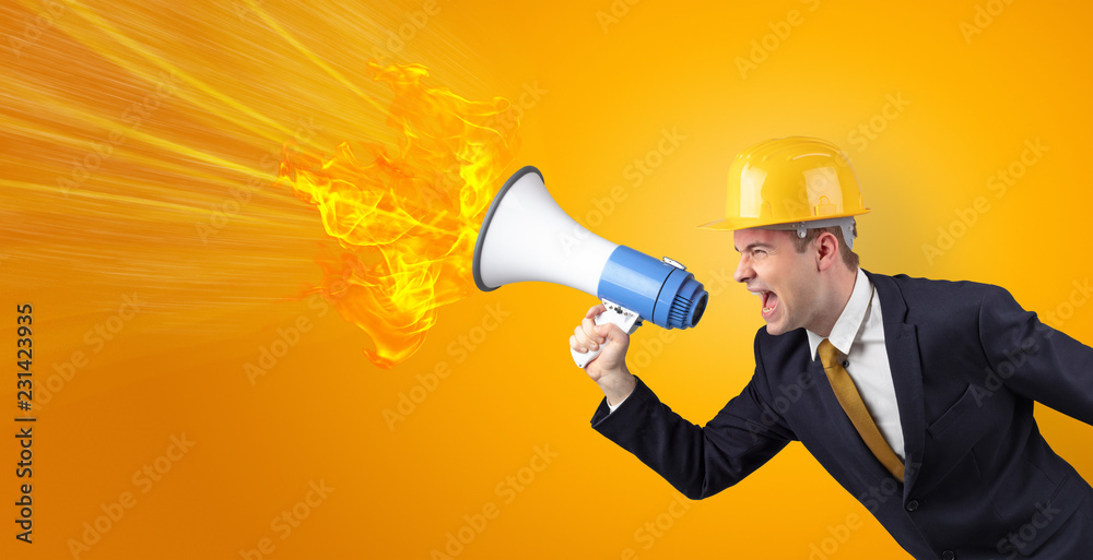 Fototapeta premium Young architect constructor yelling with megaphone with copyspace