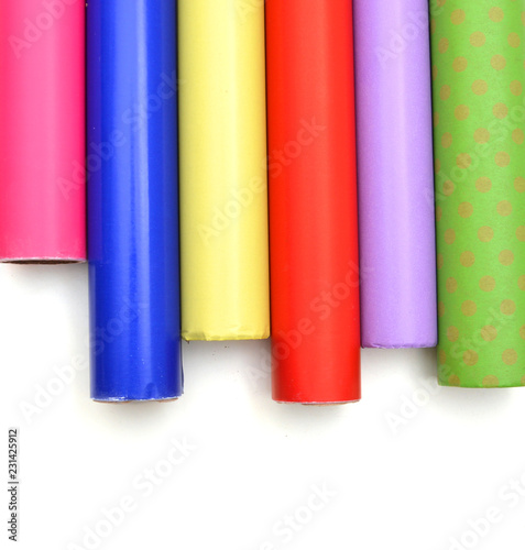 Rolls of colorful wrapping paper on white background