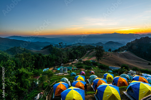tent in the sunset overlooking mountains photo