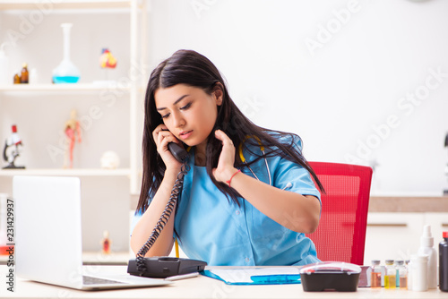 Young beautiful female doctor working in the clinic 