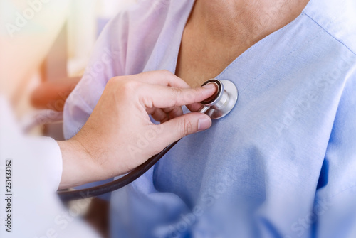 healthy concept; Doctor checking patient's heart with stethoscope at a hospital