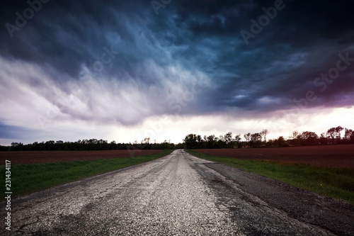 Storm clouds over a country road